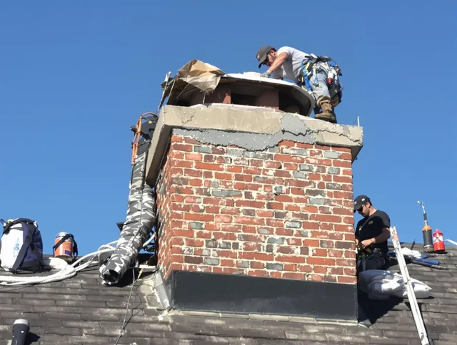 Westwood Chimney Sweep installing a custom chimney crown in Westwood, MA